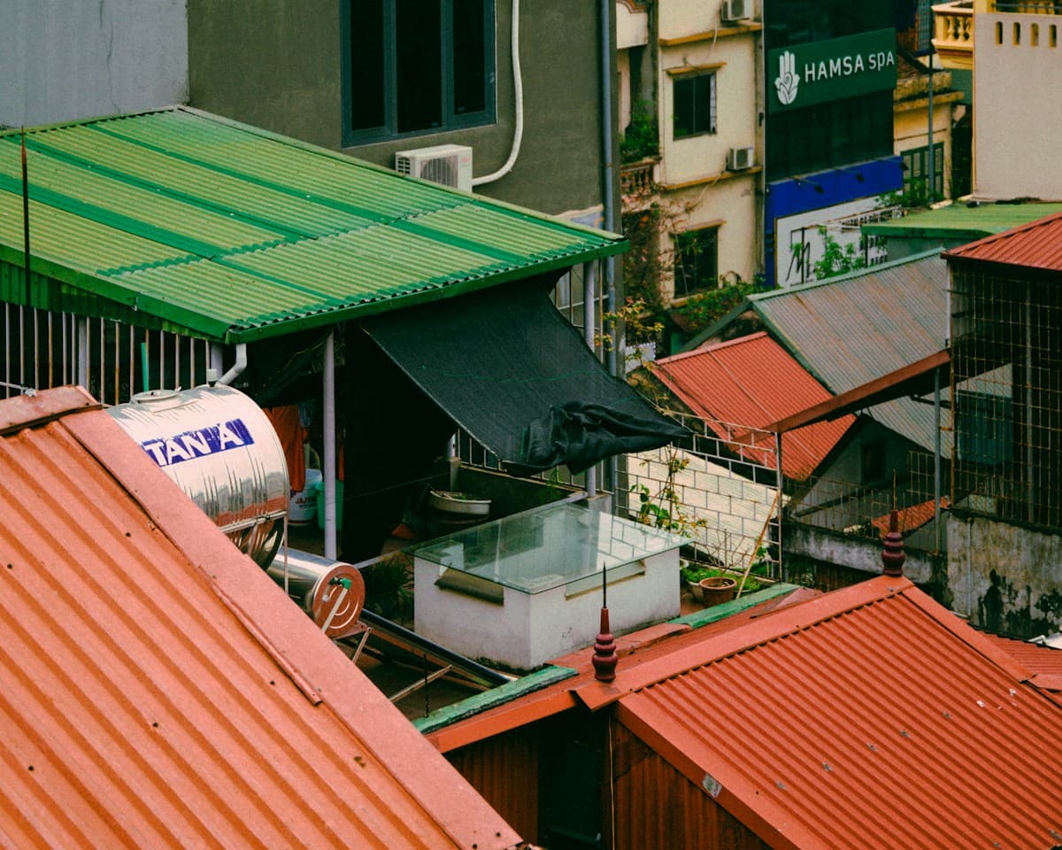 Coloured corrugated roofing sheets on rooftops